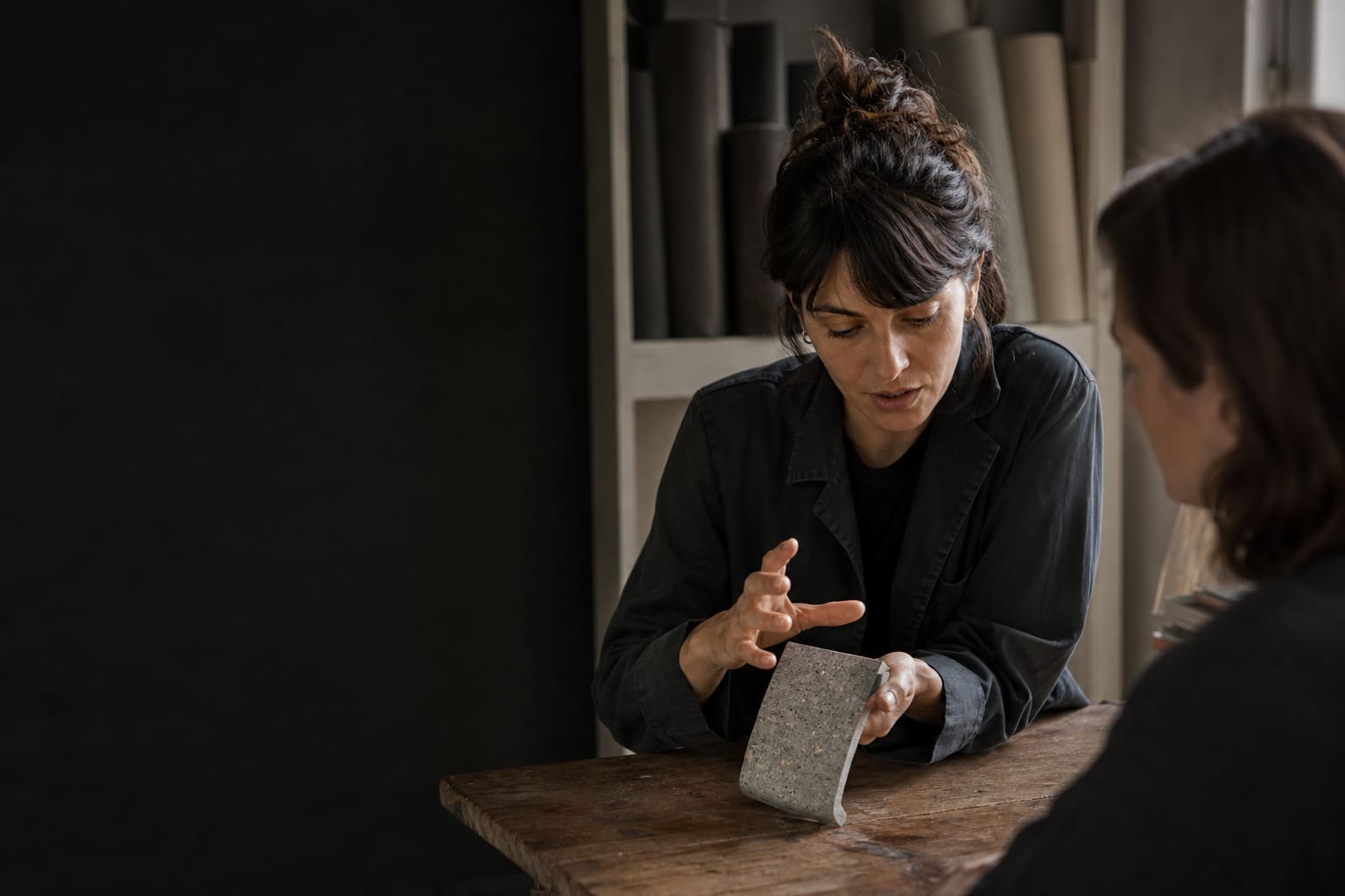 Business professional rehearsing a Spanish product explanation with a colleague