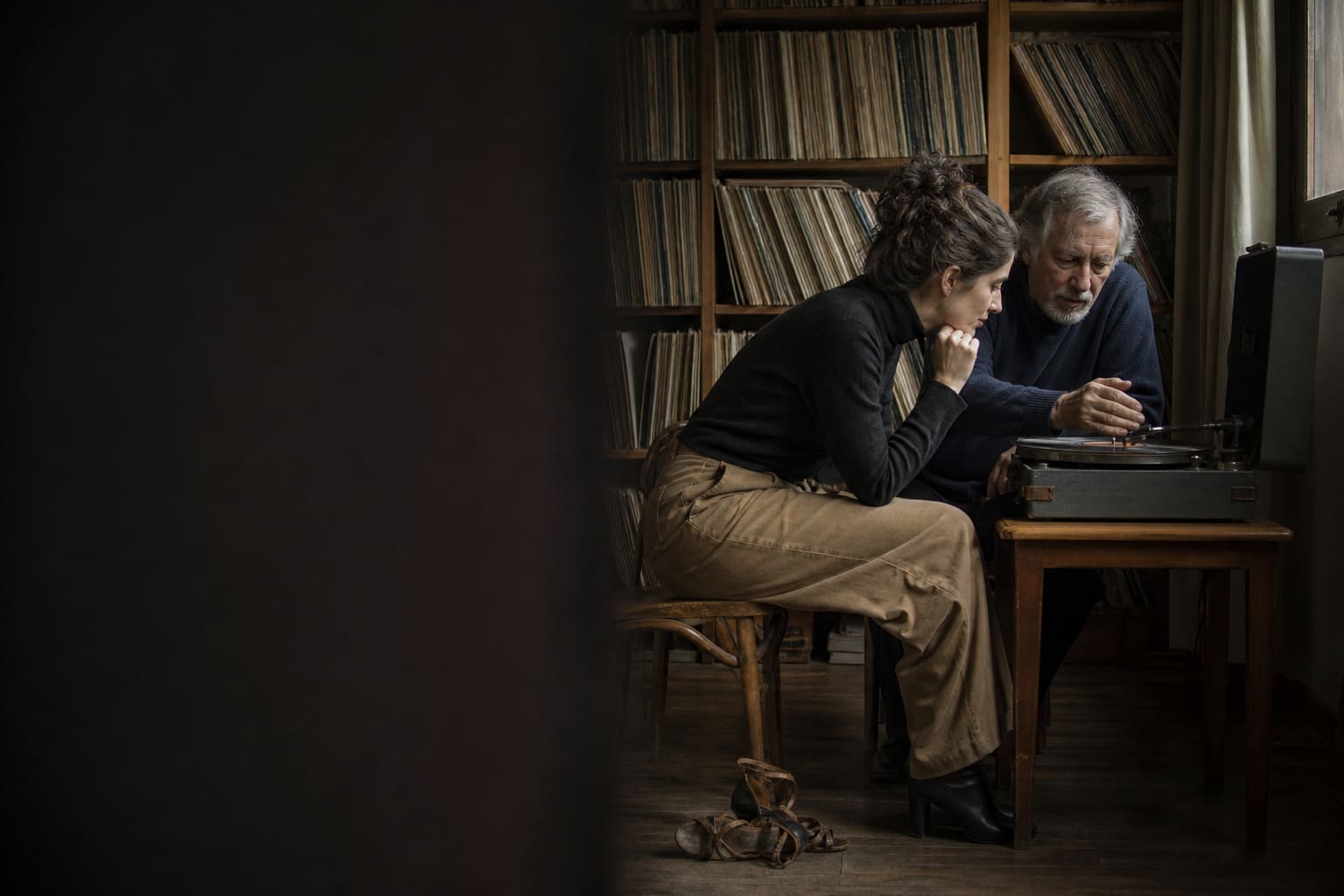 Tango enthusiast discussing a record with a music archivist in Buenos Aires